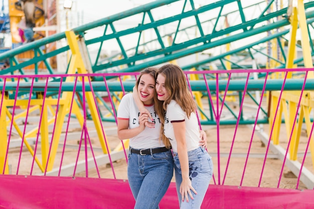 Happy friends having fun in the amusement park