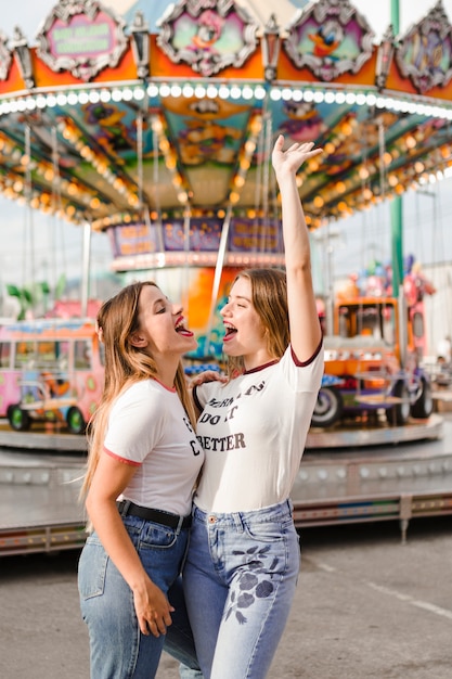 Free photo happy friends having fun in the amusement park