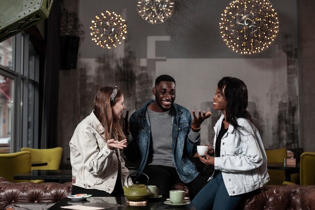 Happy friends laughing in cafe