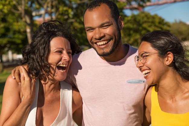 Happy friends laughing in park