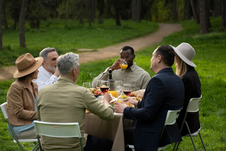 Free Photo happy friends partying in nature medium shot