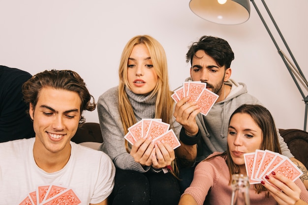 Happy friends playing cards game