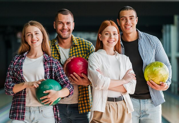 Happy friends posing in a bowling club