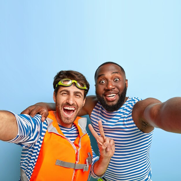 Happy friends posing with beach items