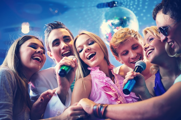 Free Photo happy friends singing karaoke together