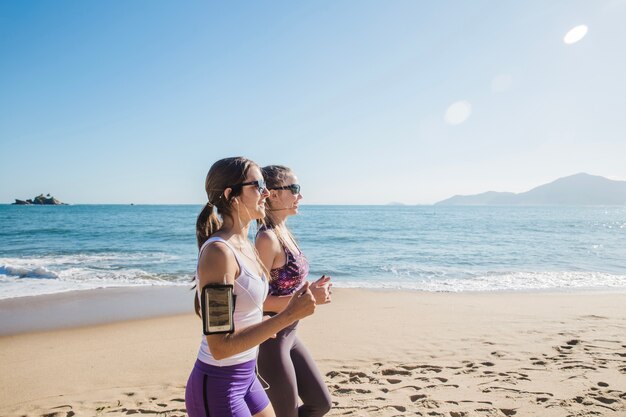 Happy friends training on the beach