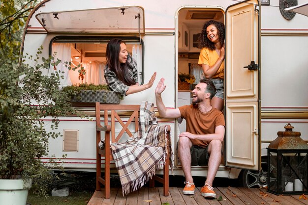 Free photo happy friends in a van high five