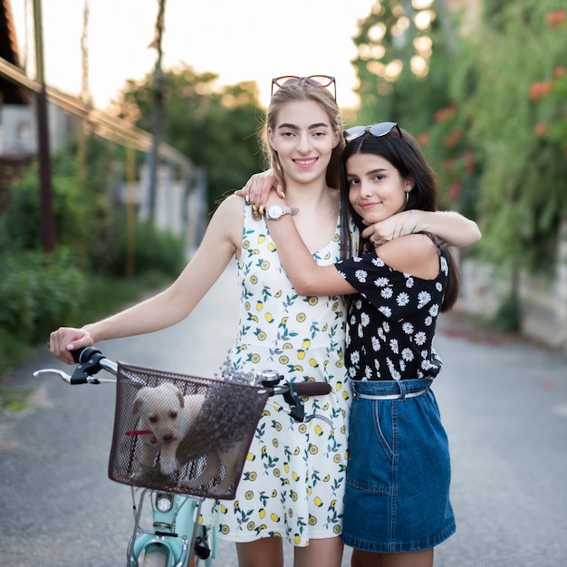 Amici felici con la bicicletta guardando la telecamera