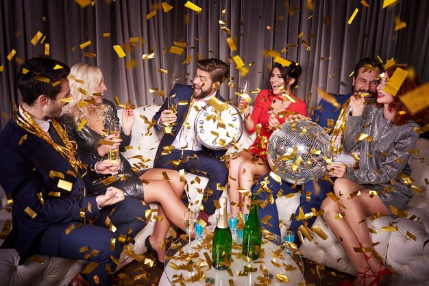 Happy friends with champagne celebrating