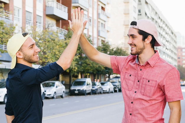 Happy gay couple giving high five