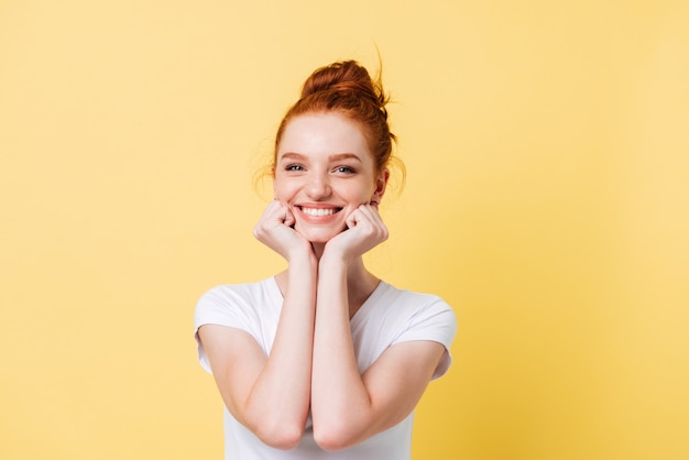 Happy ginger woman in t-shirt reclines on hands