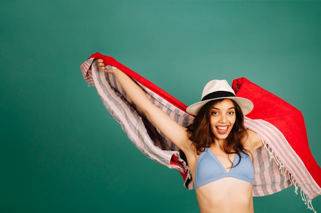 Happy girl in bikini waving towel