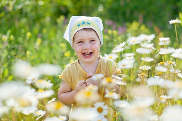 Free photo happy girl in daisy meadow