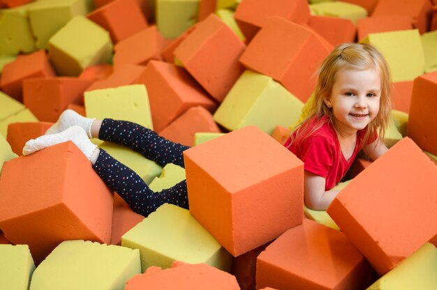 Happy girl enjoying soft blocks playground