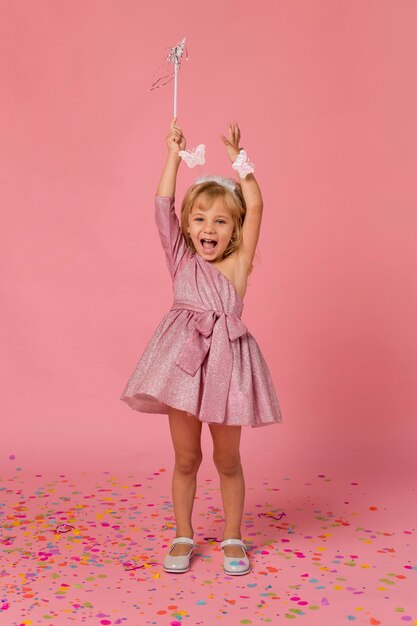 Happy girl in fairy costume with confetti