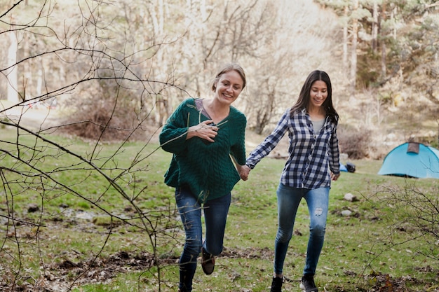 Free photo happy girl holding her friend's hand