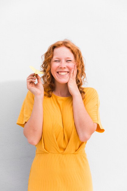 Happy girl holding paper plane