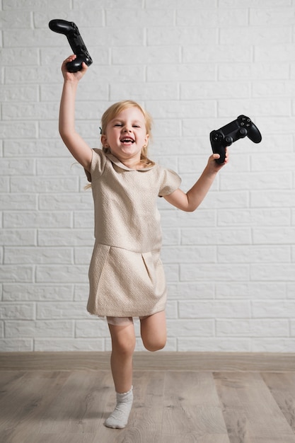 Free photo happy girl holding two joysticks