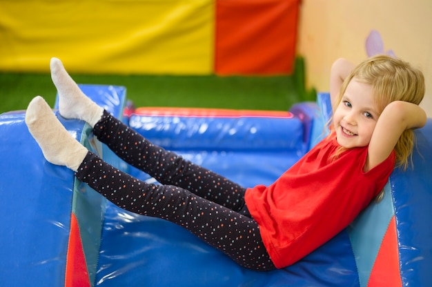 Free photo happy girl laying side view