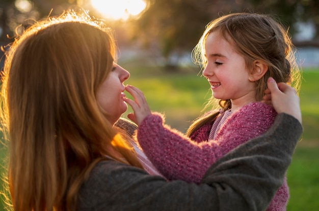 Free photo happy girl and mother side view