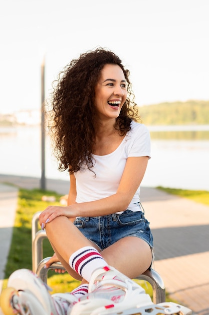 Free photo happy girl posing in rollerblades