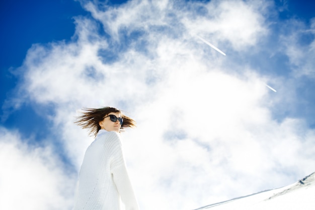 Free photo happy girl resting in the snow and the sun