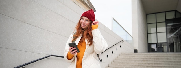 happy-girl-student-red-hat-holds-smartphone-tourist-looks-map-app-her-phone-explores_1258-196354.jpg