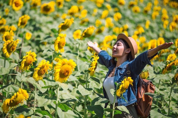 Happy girl in sunflower field.