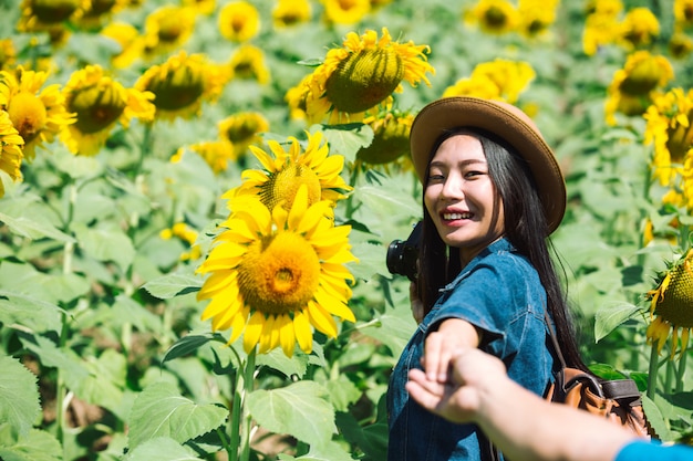Happy girl in sunflower field.