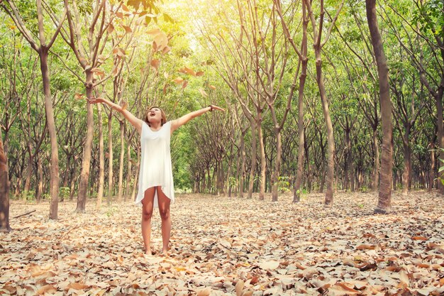 Happy girl throwing dry leaves