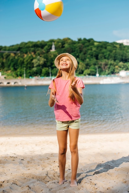 Free photo happy girl throwing wind ball