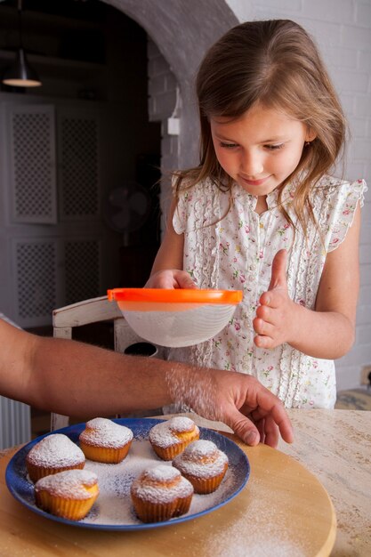 Happy girl using a strainer