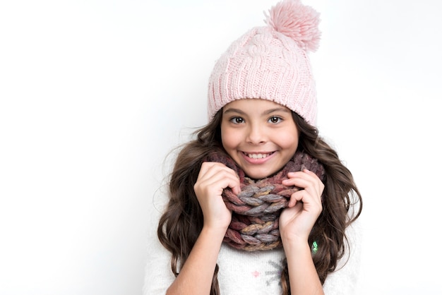 Happy girl with hands on scarf from neck