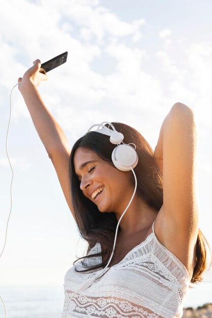 happy girl with headphones outdoors