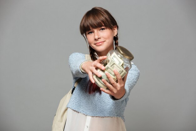 Happy girl  with jar full of money