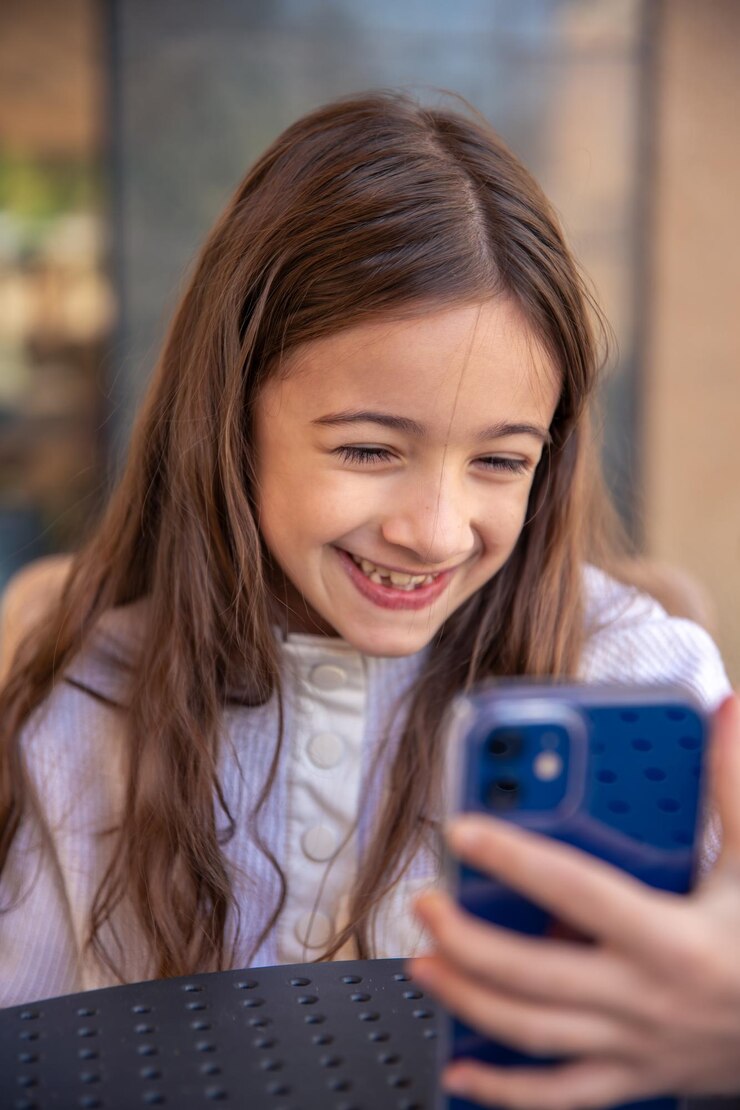 Free Photo happy girl with phone portrait of attractive cheerful amazed girl using phone