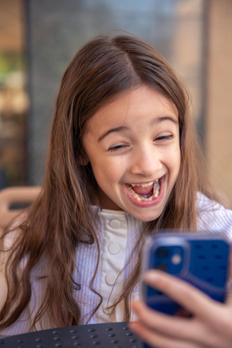 Free Photo happy girl with phone portrait of attractive cheerful amazed girl using phone