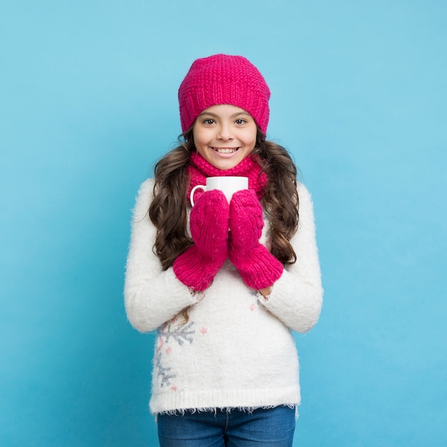 Happy girl with winter clothes smiling