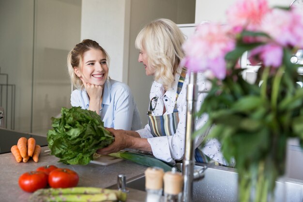 Happy grandmother and her granddaughter cooking together