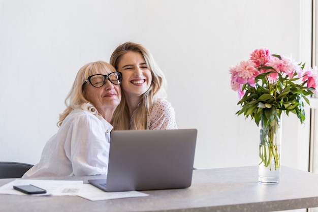 Happy grandmother hugging her young granddaughter