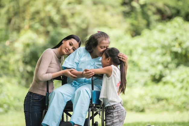 그녀의 딸과 공원에서 손자와 휠체어에 행복 할머니 행복 한 생활 행복 한 시간입니다.