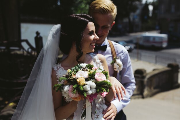 Happy groom hugging his wife