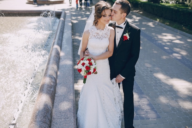 Happy groom kissing bride's cheek