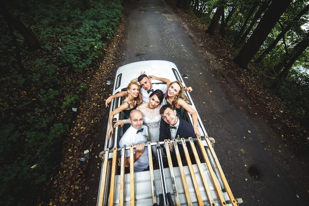 Free photo happy guests with bride and groom