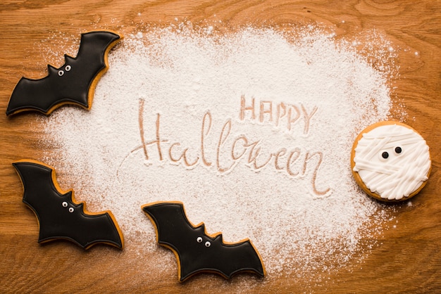 Happy halloween bats on wooden table