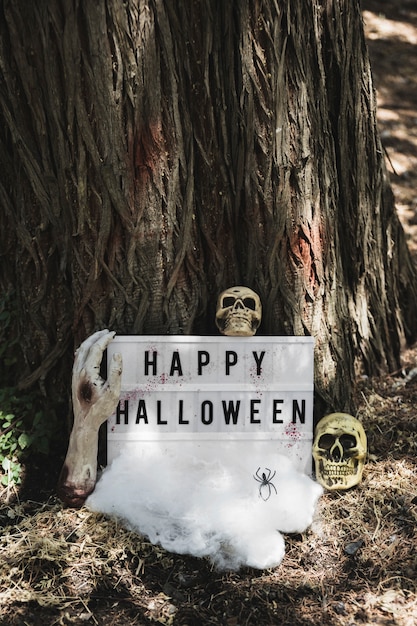 Happy Halloween inscription decorated with skulls