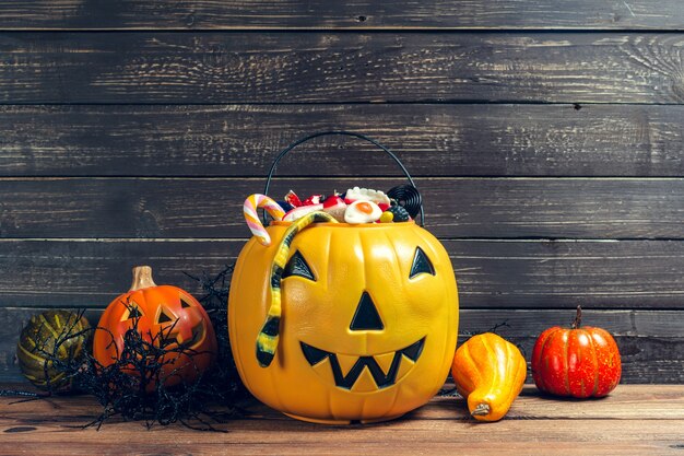 Happy halloween! pumpkin with candy in the home.