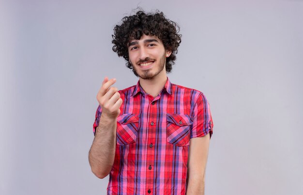 A happy handsome man with curly hair in checked shirt 
