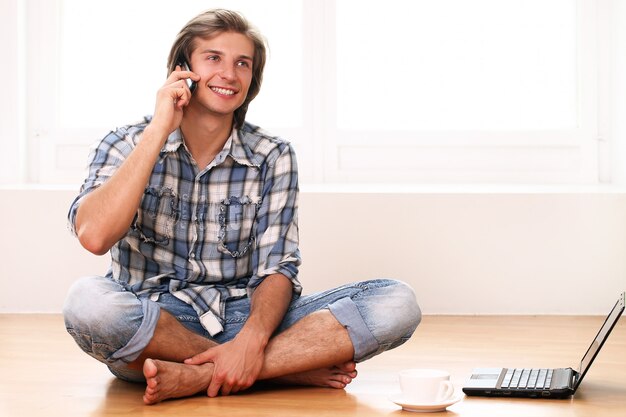 Happy and handsome using cell phone