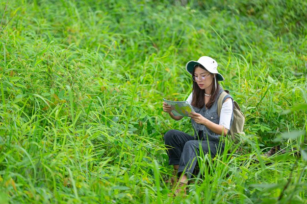 A happy hiker walks through the jungle with a backpack.